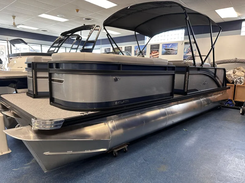 The Image of 2025 Qwest 8522 Lanai Tri-Toon pontoon boat displayed indoors. - 0
