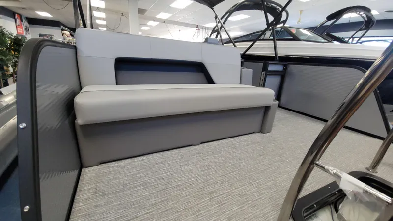 Slide: The Image of 2025 Qwest E22 boat interior with gray seating and modern design. - 11