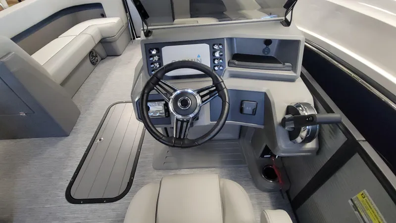 Slide: The Image of Interior of 2025 Qwest E22 boat, featuring modern steering console and seating. - 3