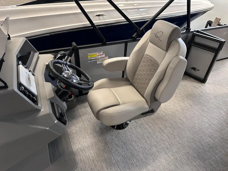 Slide: The Image of Captain's chair in 2025 Qwest 8522 Lanai Tri-Toon boat, featuring luxurious design and steering console. - 5