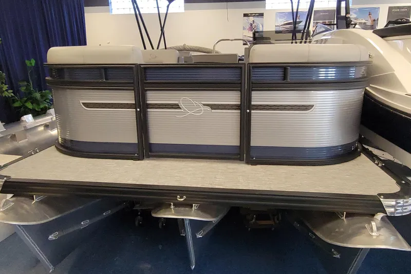 Slide: The Image of 2025 Qwest E22 pontoon boat displayed indoors, showcasing sleek design and modern features. - 6