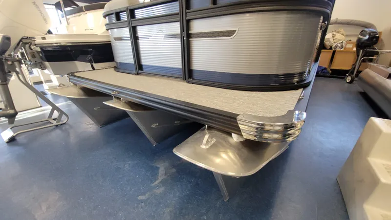 Slide: The Image of 2025 Qwest E22 pontoon boat with sleek aluminum pontoons and modern design. - 7