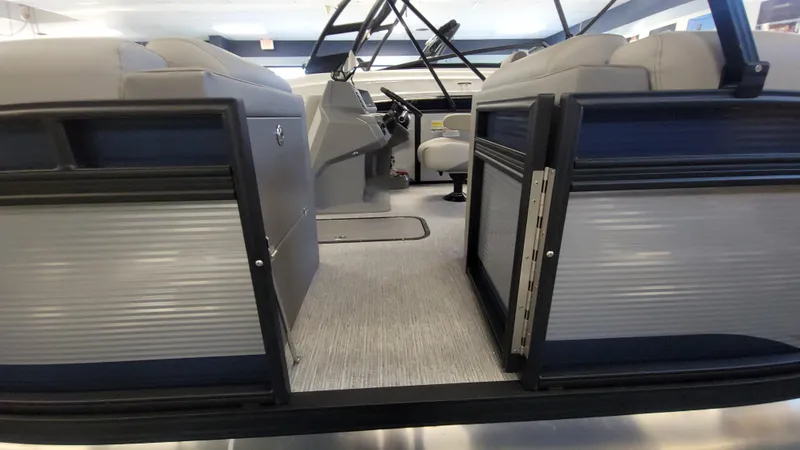 Slide: The Image of 2025 Qwest E22 pontoon boat interior with seating and steering console. - 9