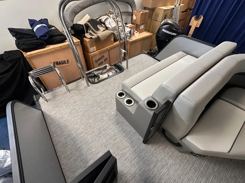 Slide: The Image of 2025 Qwest 8522 Lanai Tri-Toon interior with gray seating and storage boxes. - 4