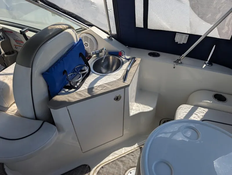 Slide: The Image of 2006 Sea Ray 240 Sundancer interior with sink and seating area. - 12