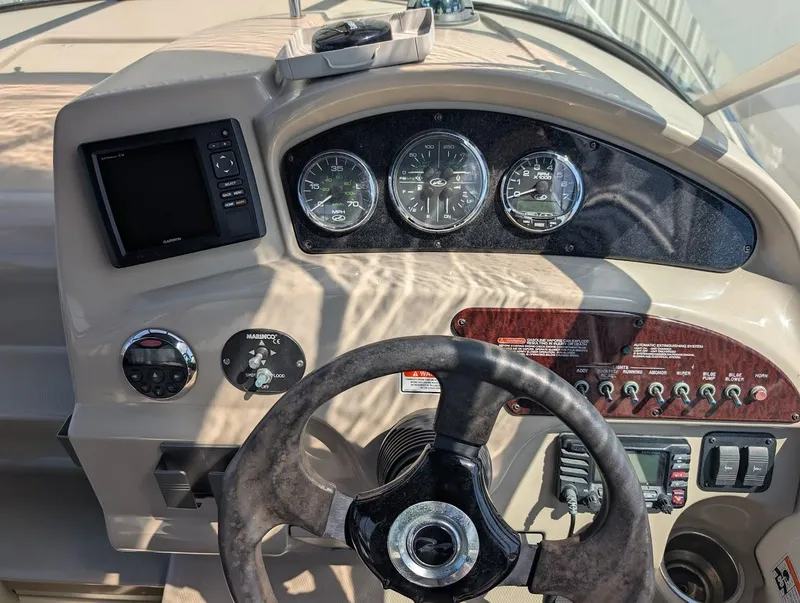 Slide: The Image of 2006 Sea Ray 240 Sundancer dashboard with gauges, steering wheel, and control panel. - 17