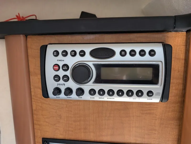 Slide: The Image of Boat stereo system in 2006 Sea Ray 240 Sundancer cabin, featuring control buttons and display. - 25