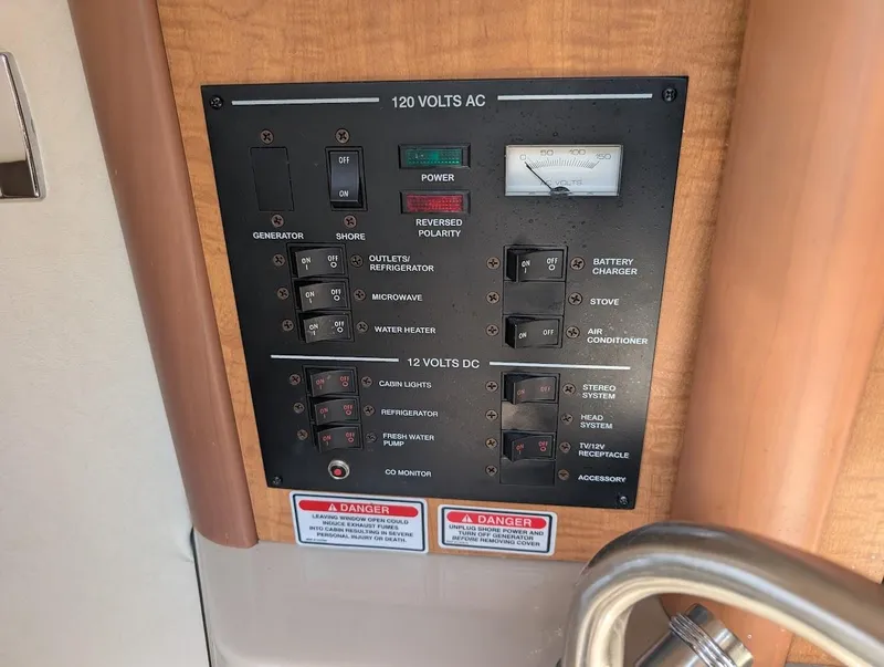 Slide: The Image of Electrical control panel on a 2006 Sea Ray 240 Sundancer boat. - 26