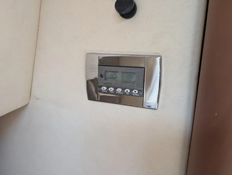 Slide: The Image of Control panel on a 2006 Sea Ray 240 Sundancer boat interior. - 27