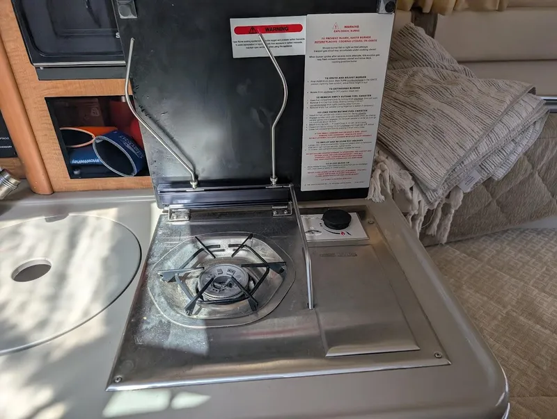 Slide: The Image of 2006 Sea Ray 240 Sundancer interior with compact stove and countertop. - 28