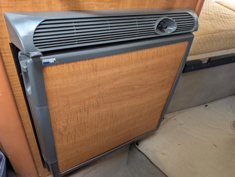 Slide: The Image of 2006 Sea Ray 240 Sundancer cabin refrigerator with wood paneling. - 29