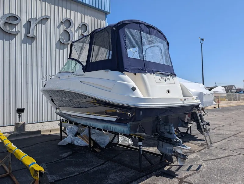 Slide: The Image of 2006 Sea Ray 240 Sundancer boat on dry dock, covered and ready for maintenance. - 3