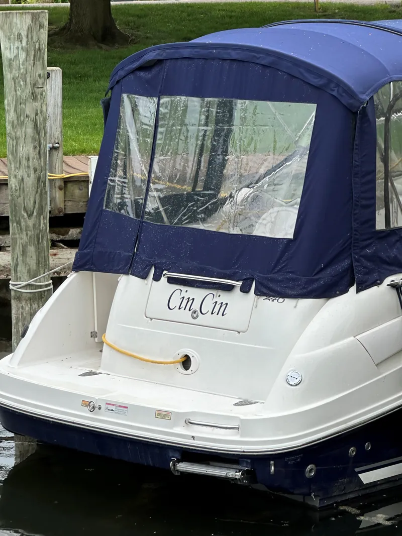 Slide: The Image of 2006 Sea Ray 240 Sundancer boat docked with blue canopy. - 6