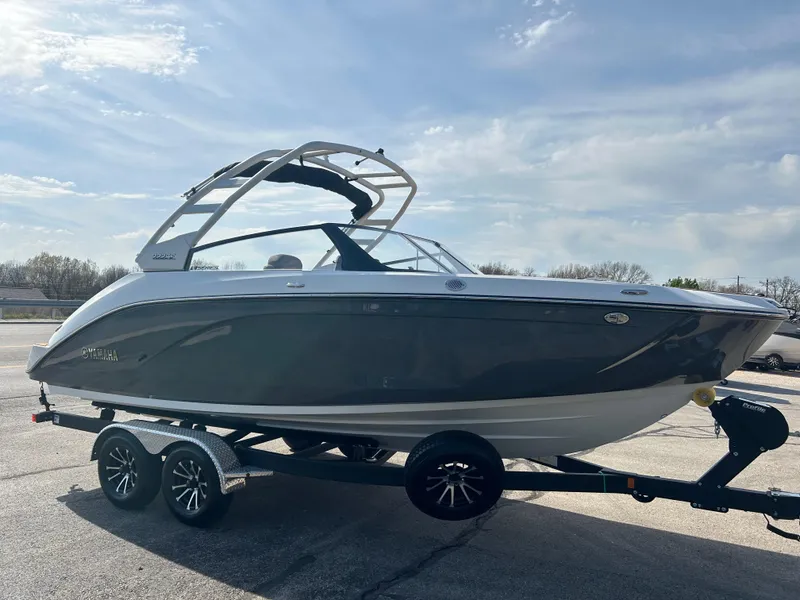 Slide: The Image of 2025 Yamaha Boats 222SE on trailer under clear sky. - 2