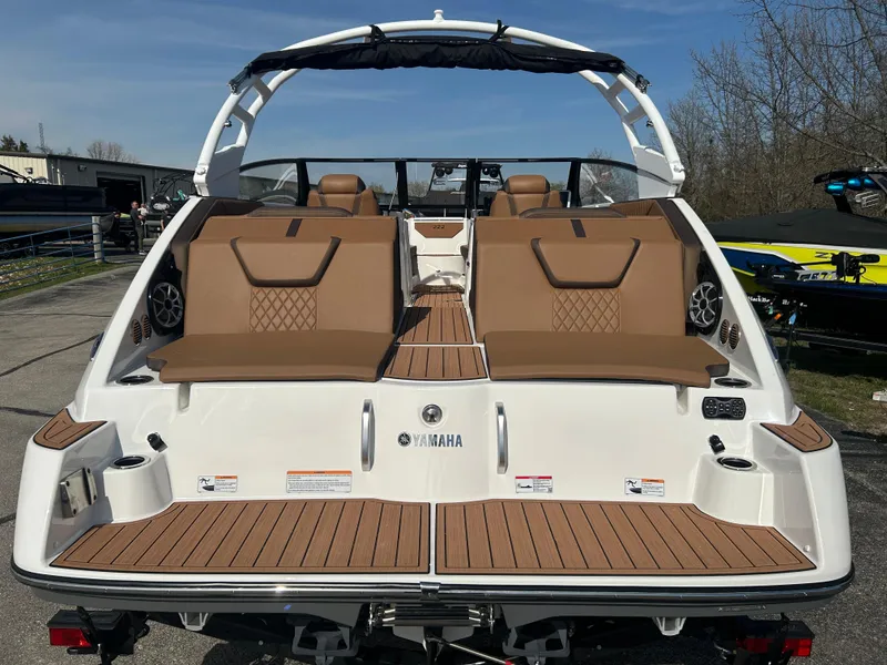 Slide: The Image of 2025 Yamaha Boats 222SE with sleek design and spacious seating, docked outdoors. - 5
