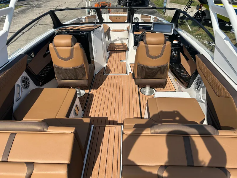 Slide: The Image of 2025 Yamaha Boats 222SE interior with luxurious brown seating and sleek design. - 6