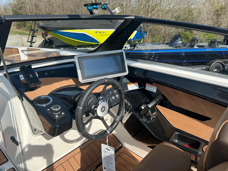 Slide: The Image of 2025 Yamaha Boats 222SE dashboard with steering wheel and touchscreen display. - 7