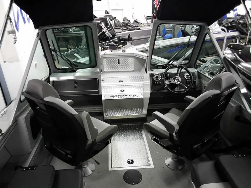Slide: The Image of 2024 Smoker Craft Phantom 20 X2 OS boat interior with steering wheel and seating. - 11