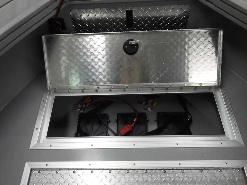 Slide: The Image of 2024 Smoker Craft Phantom 20 X2 OS boat storage compartment with diamond plate finish. - 14