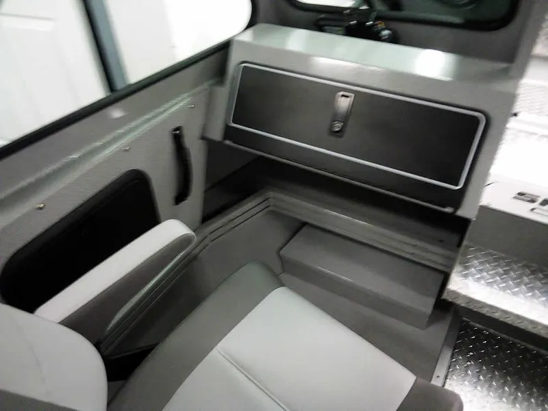 Slide: The Image of 2024 Smoker Craft Phantom 20 X2 OS interior with seating and storage compartment. - 16