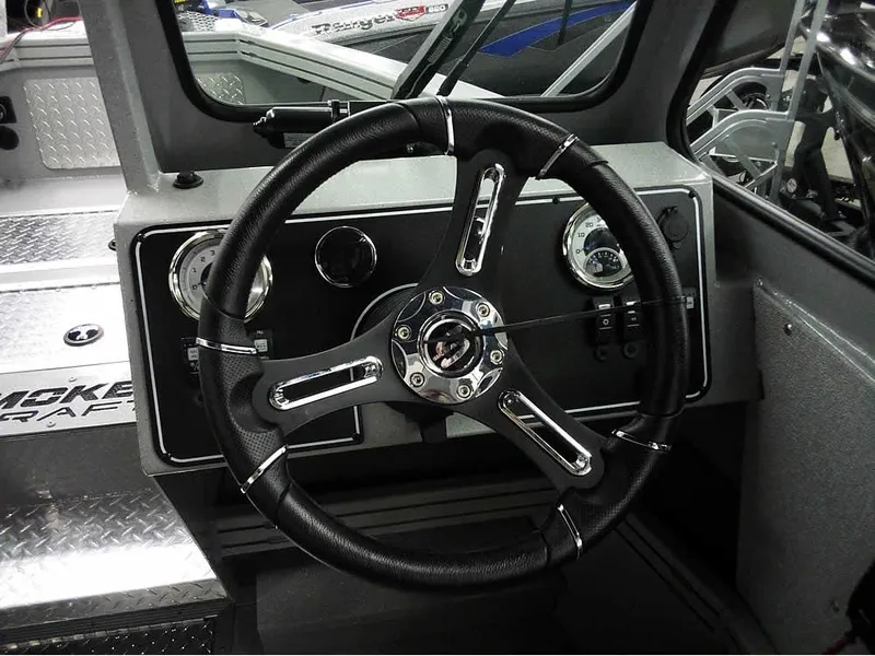 Slide: The Image of Steering wheel of 2024 Smoker Craft Phantom 20 X2 OS boat, featuring modern dashboard controls. - 20