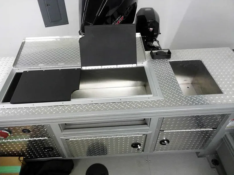 Slide: The Image of 2024 Smoker Craft Phantom 20 X2 OS boat interior with diamond plate surfaces and storage compartments. - 25