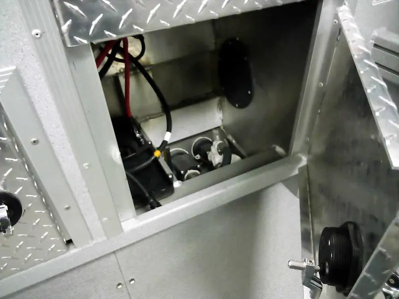 Slide: The Image of 2024 Smoker Craft Phantom 20 X2 OS boat storage compartment with wiring and metal finish. - 26