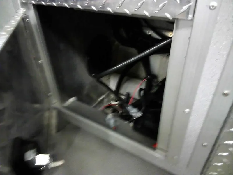 Slide: The Image of 2024 Smoker Craft Phantom 20 X2 OS interior compartment with wiring and metal framework. - 28