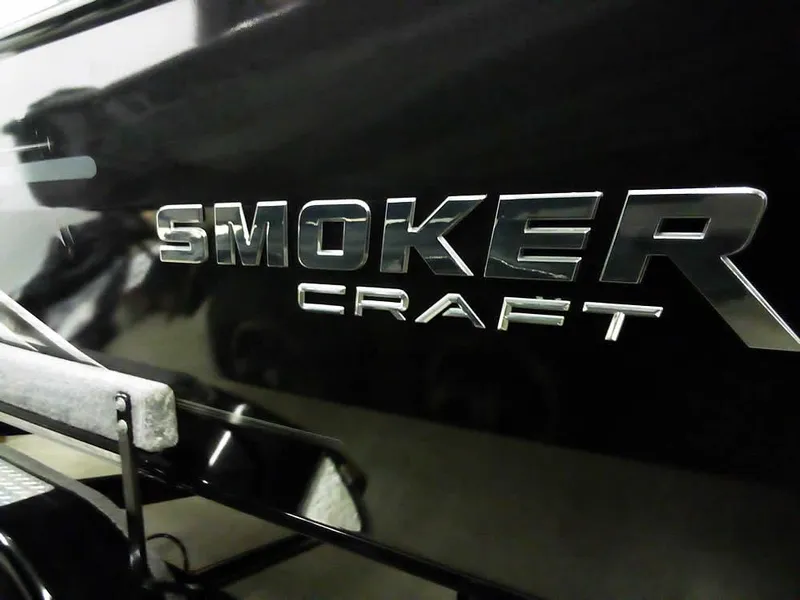 Slide: The Image of 2024 Smoker Craft Phantom 20 X2 OS boat logo on sleek black surface. - 30