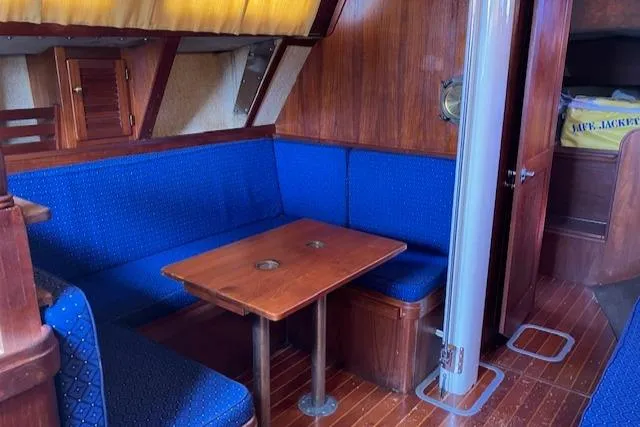 Slide: The Image of Interior of 1981 S2 11.0A sailboat with blue seating and wooden table. - 17