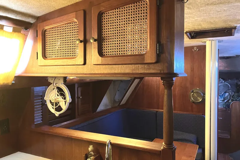 Slide: The Image of Interior of 1981 S2 11.0A sailboat with wooden cabinetry and seating area. - 20