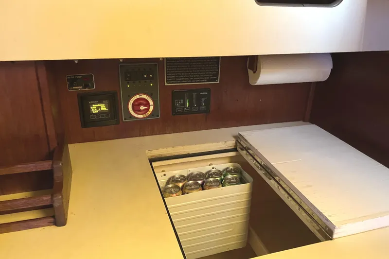 Slide: The Image of Interior of 1981 S2 11.0A sailboat with control panel and storage compartment. - 21