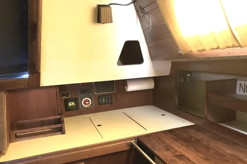Slide: The Image of 1981 S2 11.0A yacht interior with wooden cabinetry and control panel. - 22
