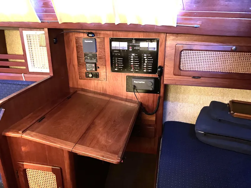 Slide: The Image of 1981 S2 11.0A sailboat interior with navigation equipment and wooden cabinetry. - 23