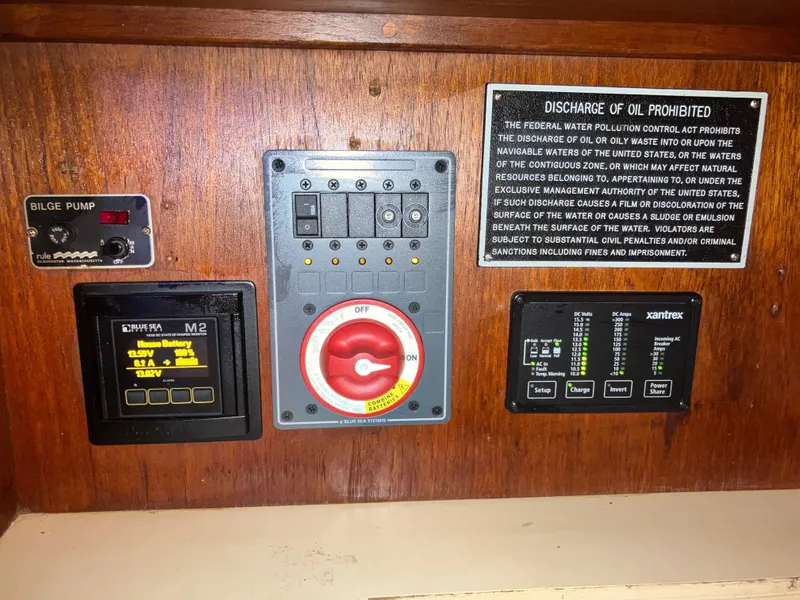 Slide: The Image of Control panel of a 1981 S2 11.0A boat with bilge pump and oil discharge warning. - 24