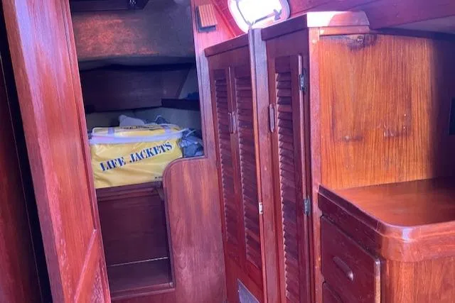 Slide: The Image of Interior of 1981 S2 11.0A sailboat with wooden cabinets and life jackets. - 30