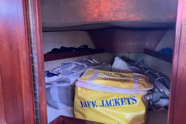 Slide: The Image of Storage area in 1981 S2 11.0A sailboat with life jackets and bags. - 31