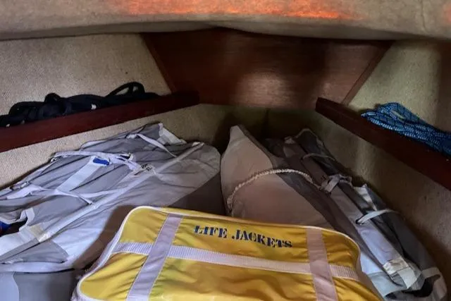 Slide: The Image of Storage area in 1981 S2 11.0A sailboat with life jackets and gear. - 32