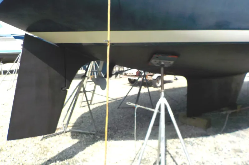 Slide: The Image of 1981 S2 11.0A sailboat hull and rudder on stands in a boatyard. - 38