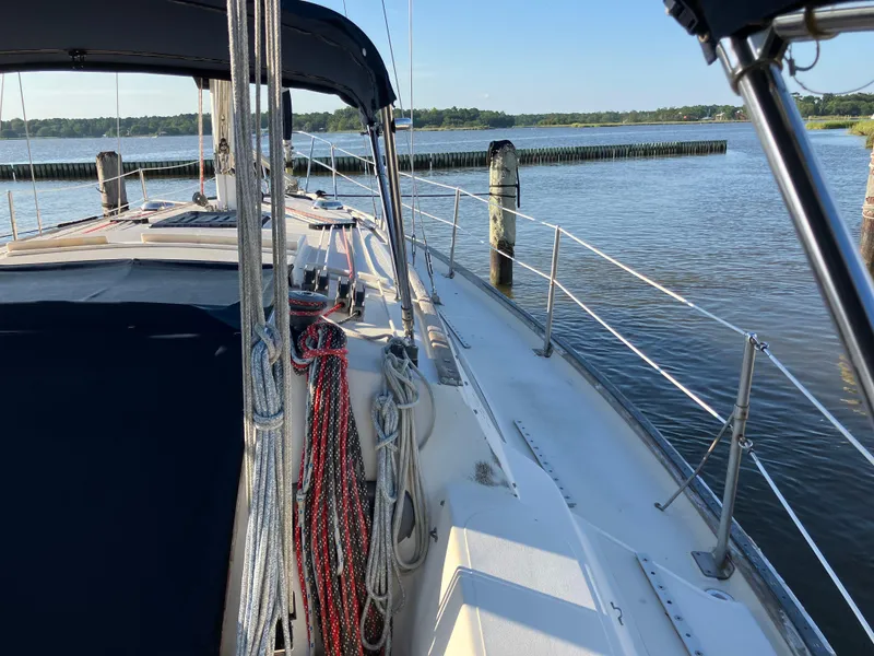 Slide: The Image of S2 11.0A sailboat from 1981 docked by a serene waterfront. - 7