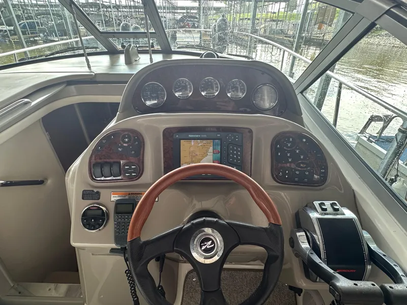 Slide: The Image of 2006 Sea Ray 300 Sundancer helm with navigation controls and gauges. - 4