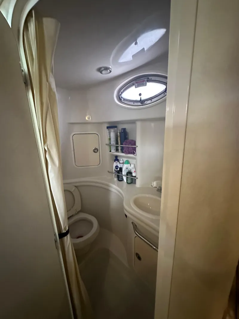 Slide: The Image of Compact bathroom in a 2006 Sea Ray 300 Sundancer boat with shower and storage. - 7