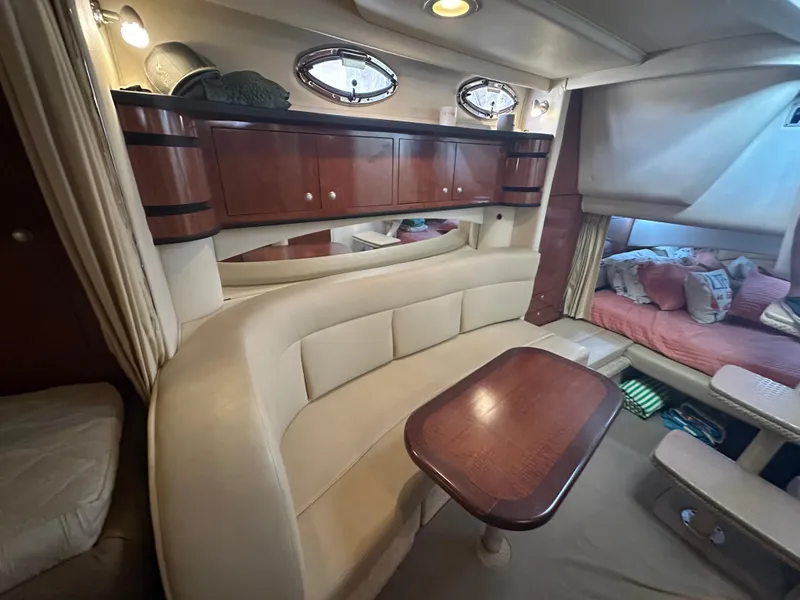 Slide: The Image of Luxurious interior of 2006 Sea Ray 300 Sundancer with elegant seating and wooden cabinetry. - 8
