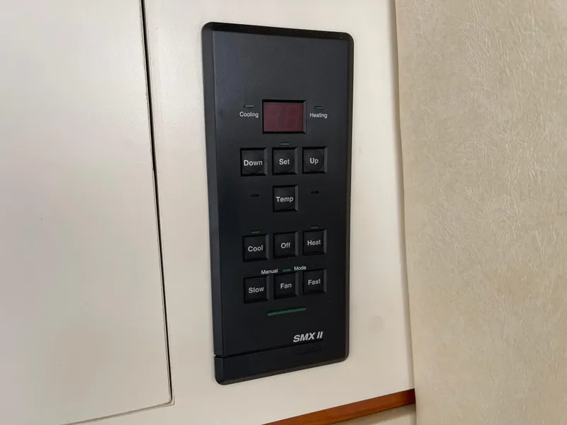 Slide: The Image of Control panel on a 2001 Sea Ray 290 Amberjack boat, featuring temperature and fan settings. - 20