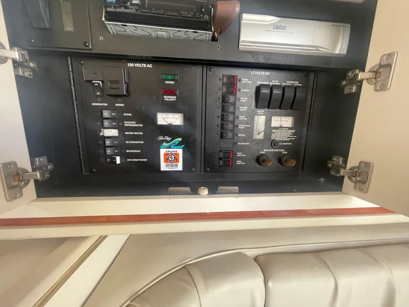Slide: The Image of Electrical panel inside a 2001 Sea Ray 290 Amberjack boat, featuring various switches and controls. - 21