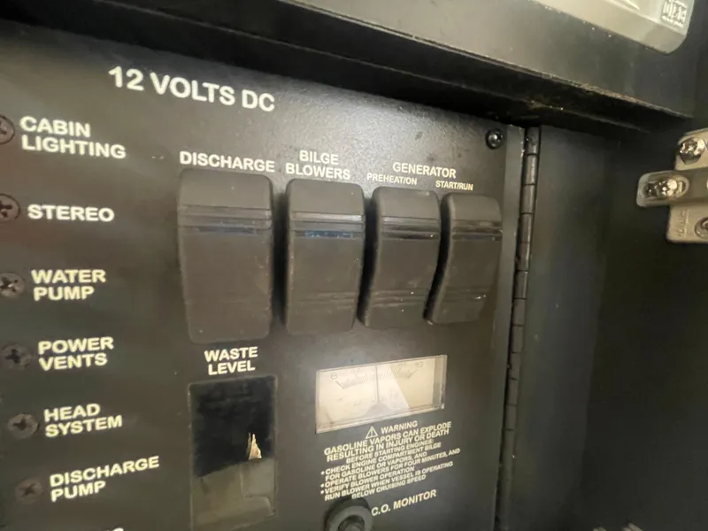 Slide: The Image of Control panel of a 2001 Sea Ray 290 Amberjack boat, featuring various switches. - 22