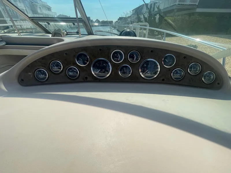 Slide: The Image of Dashboard of a 2001 Sea Ray 290 Amberjack boat with multiple gauges. - 26