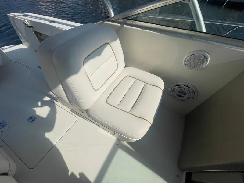 Slide: The Image of 2001 Sea Ray 290 Amberjack boat seat with white upholstery and speaker detail. - 33