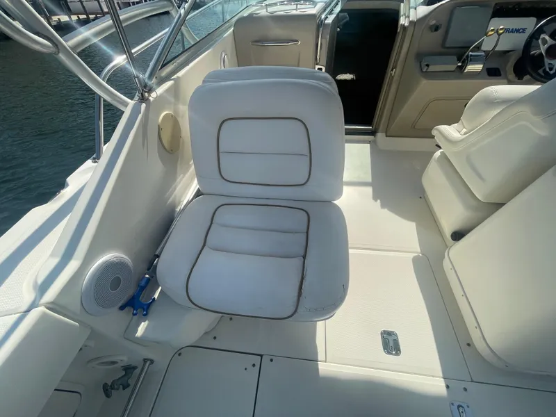 Slide: The Image of 2001 Sea Ray 290 Amberjack boat interior with white seating and helm area. - 35