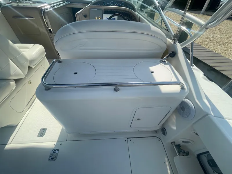 Slide: The Image of 2001 Sea Ray 290 Amberjack boat interior with white seating and control panel. - 36